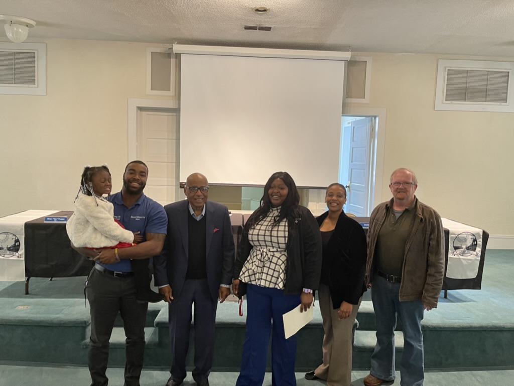 Camp Hill Community Liaison Bianca Moss poses with Dr. Earl Suttle, family and other community leaders.