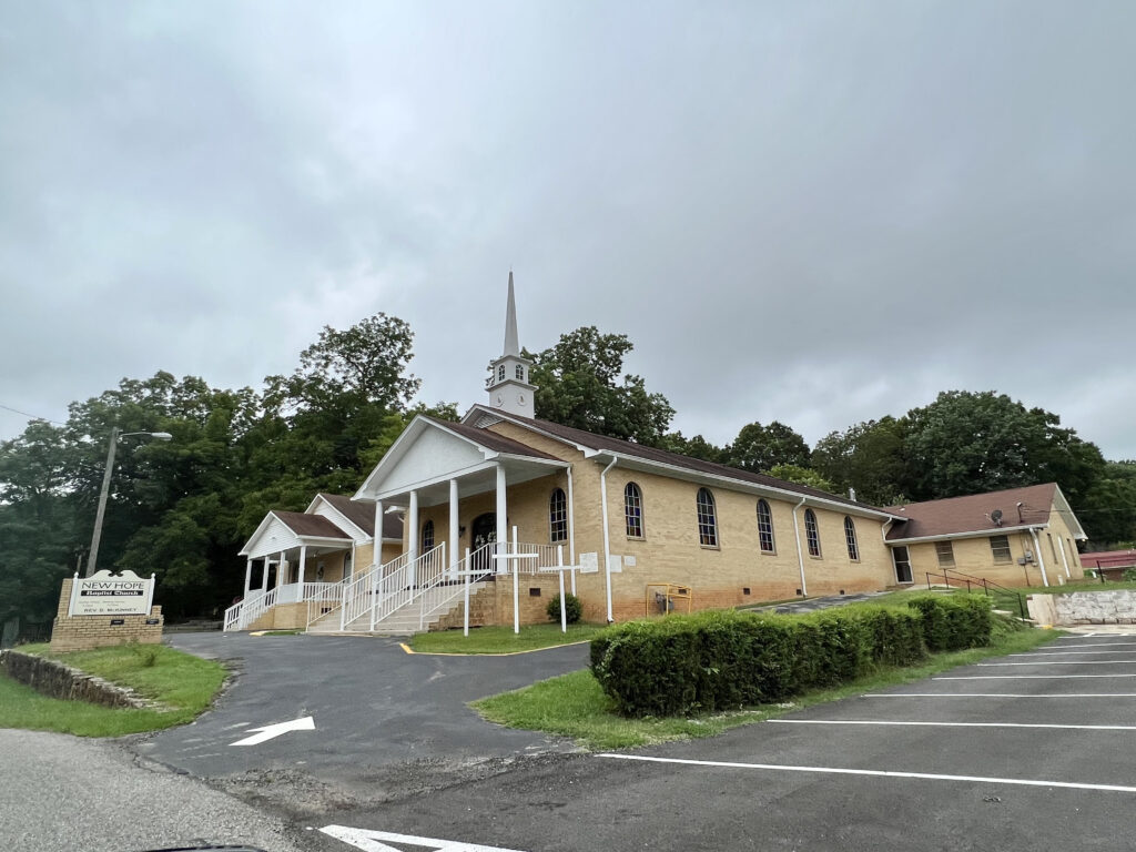 New Hope Missionary Baptist Church, a brick building with a white steeple