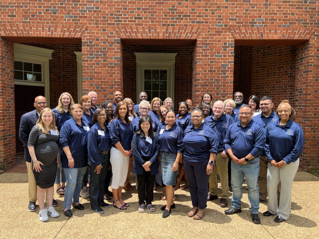 The ENI team poses at the June 2023 retreat. The team is wearing matching blue shirts from the Alabama Department of Public Health.