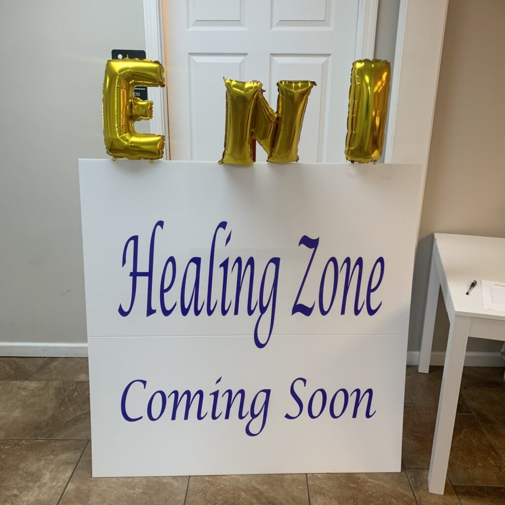 A poster says "Healing Zone Coming Soon" with ballons on top reading "ENI"